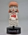 The Conjuring Universe Body Knocker Bobble Figuka - hýbací Annabelle 16 cm